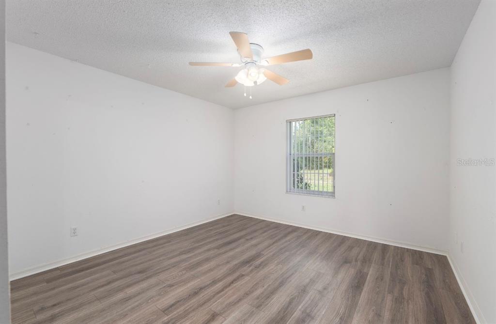 5393 Southwest 109th Place Road Ocala, FL 34476 - Photo 26 of 54 wooden floor in an empty room with a window