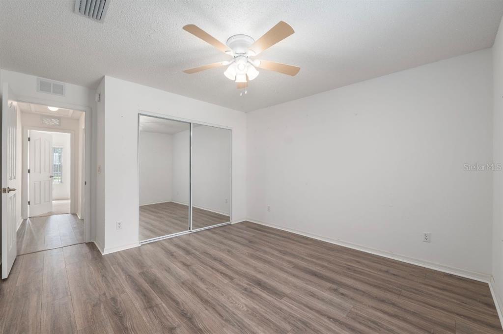 5393 Southwest 109th Place Road Ocala, FL 34476 - Photo 27 of 54 an empty room with wooden floor and door