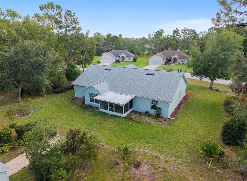5393 Southwest 109th Place Road Ocala, FL 34476 - Photo 47 of 54 a aerial view of a house with swimming pool and trees in the background