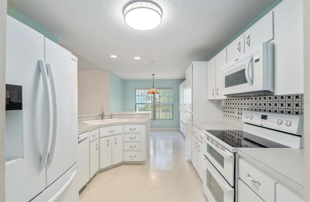 5393 Southwest 109th Place Road Ocala, FL 34476 - Photo 9 of 54 a kitchen with stainless steel appliances a white stove top oven and a refrigerator