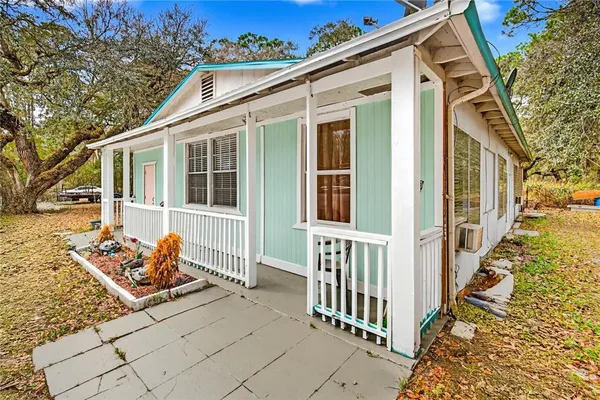 a view of a house with wooden fence