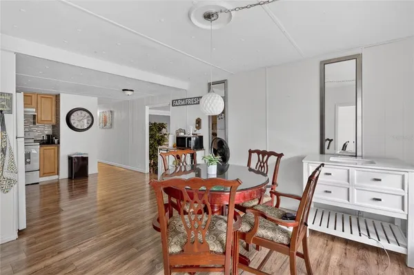 a view of a dining room with furniture and wooden floor