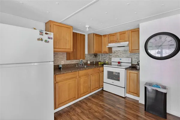 a kitchen with stainless steel appliances a stove a sink and a refrigerator