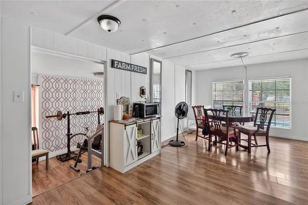 a view of a dining room with furniture window and wooden floor