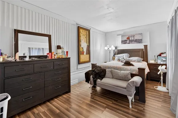 a bedroom with furniture and wooden floor