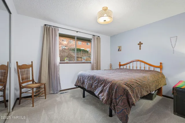 a spacious bedroom with a bed and a window