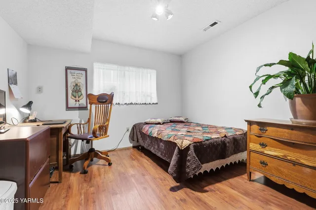 a bedroom with a bed and a table