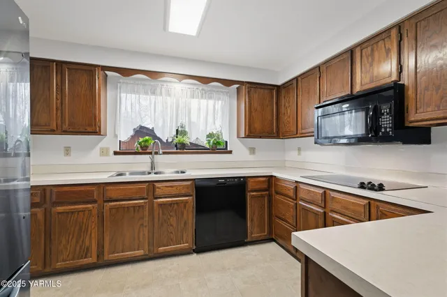 a kitchen with stainless steel appliances a sink stove and cabinets