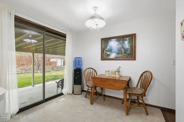 a dining room with furniture and a window