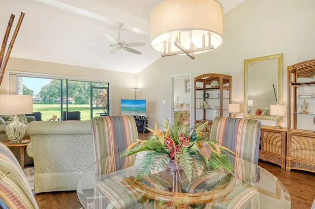 a living room with furniture a table and chairs