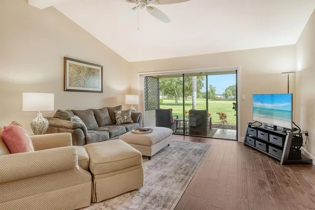 a living room with furniture and a chandelier