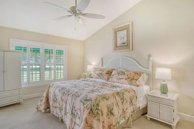 a bed sitting in a bedroom next to a window