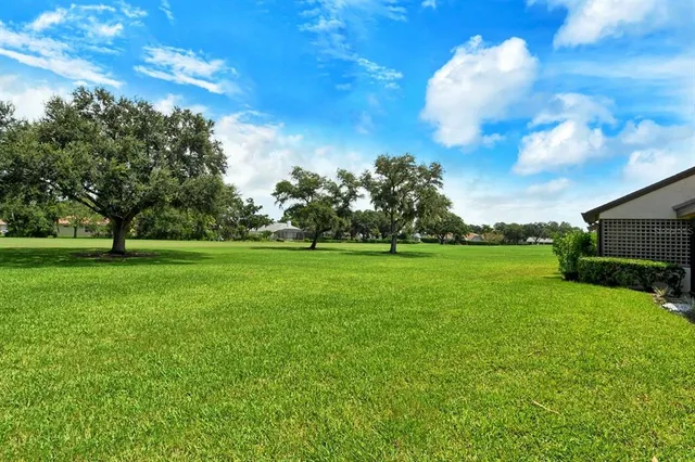 a view of a yard and front view of a house