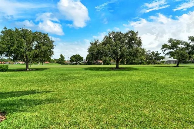a view of an ocean with boats and trees in the background