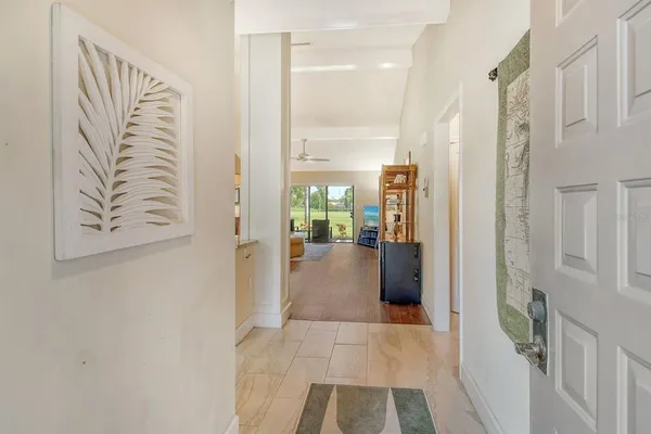 a living room with furniture and a floor to ceiling window