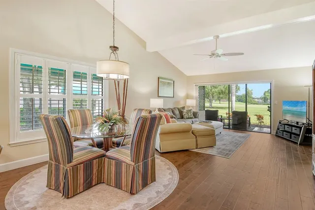 a living room with hardwood floor and a floor to ceiling window