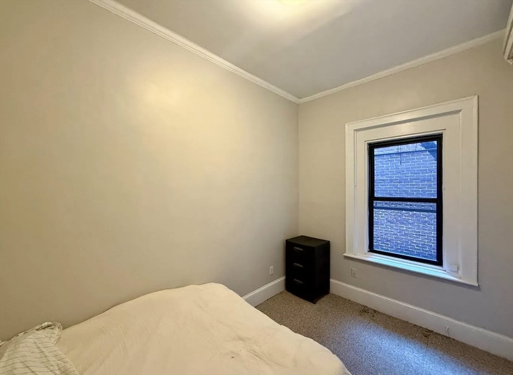 10 Fairfield Street, Unit 3 Boston, MA 02116 - Photo 6 of 8 a bedroom with a bed and a window