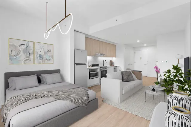 a living room with furniture and a dining table with kitchen view