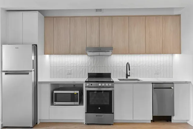 a kitchen with cabinets and appliances