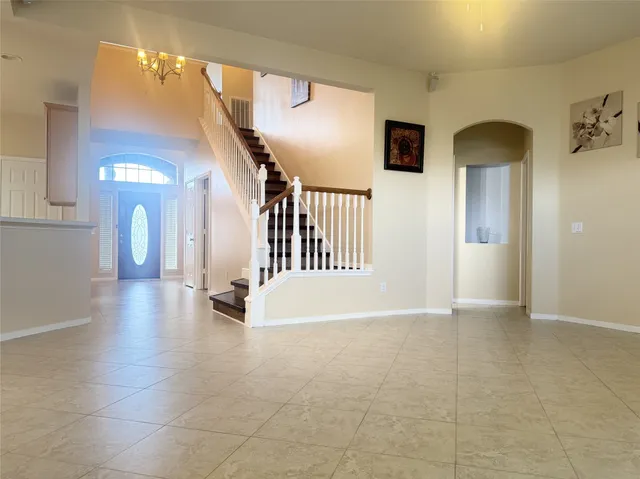 a view of a hallway with entryway wooden floor and front door