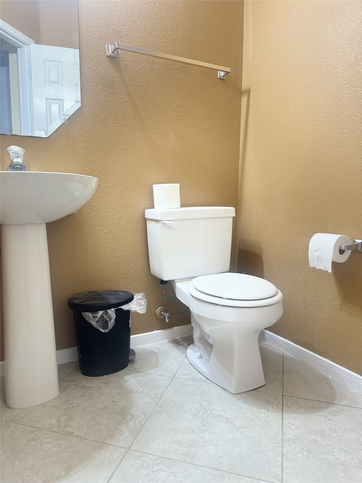 9810 Mossy Tree Lane Houston, TX 77064 - Photo 12 of 24 a white toilet sitting next to a bathroom sink