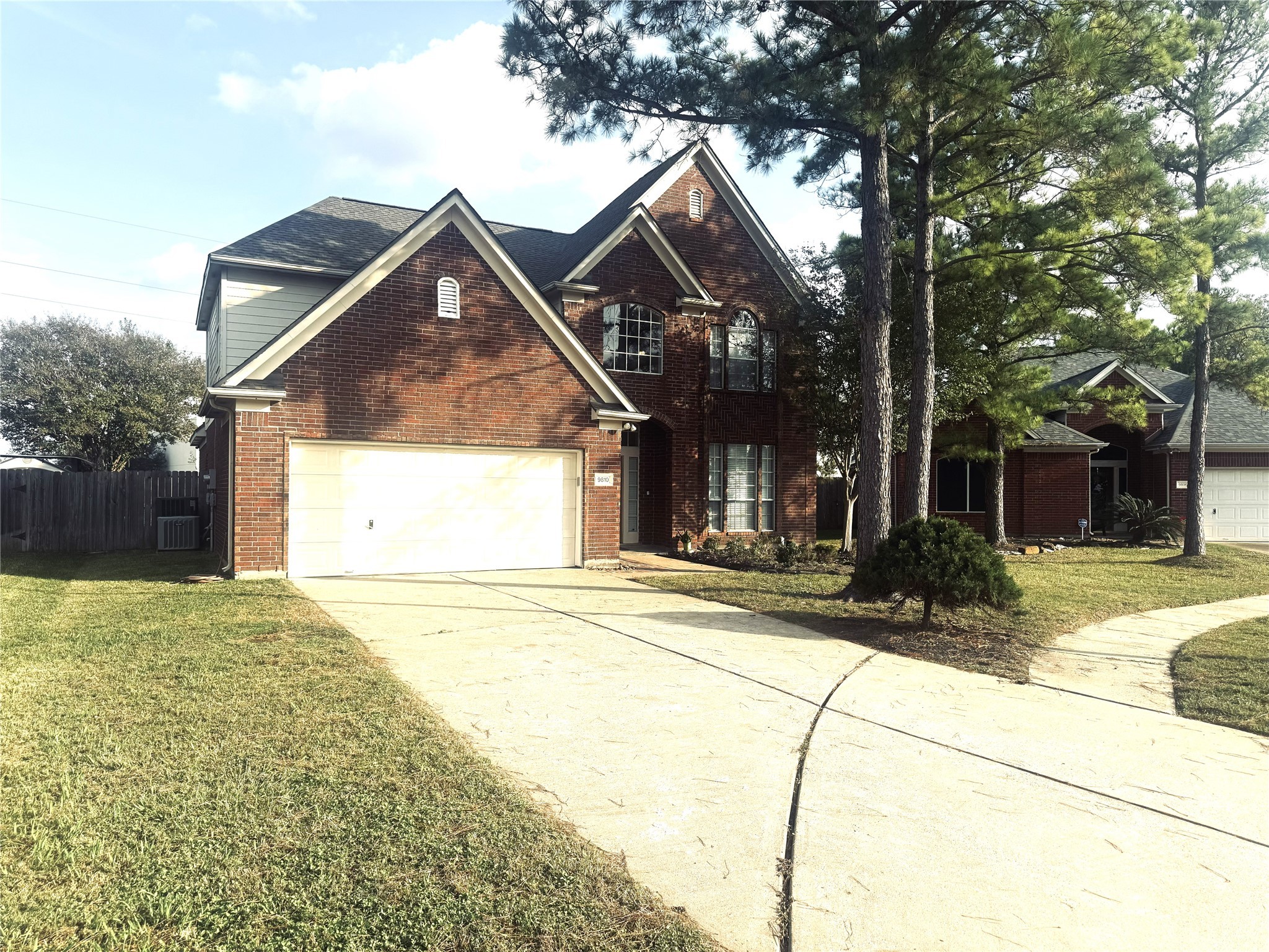 9810 Mossy Tree Lane Houston, TX 77064 - Photo 2 of 24 a view of a house with a yard and garage