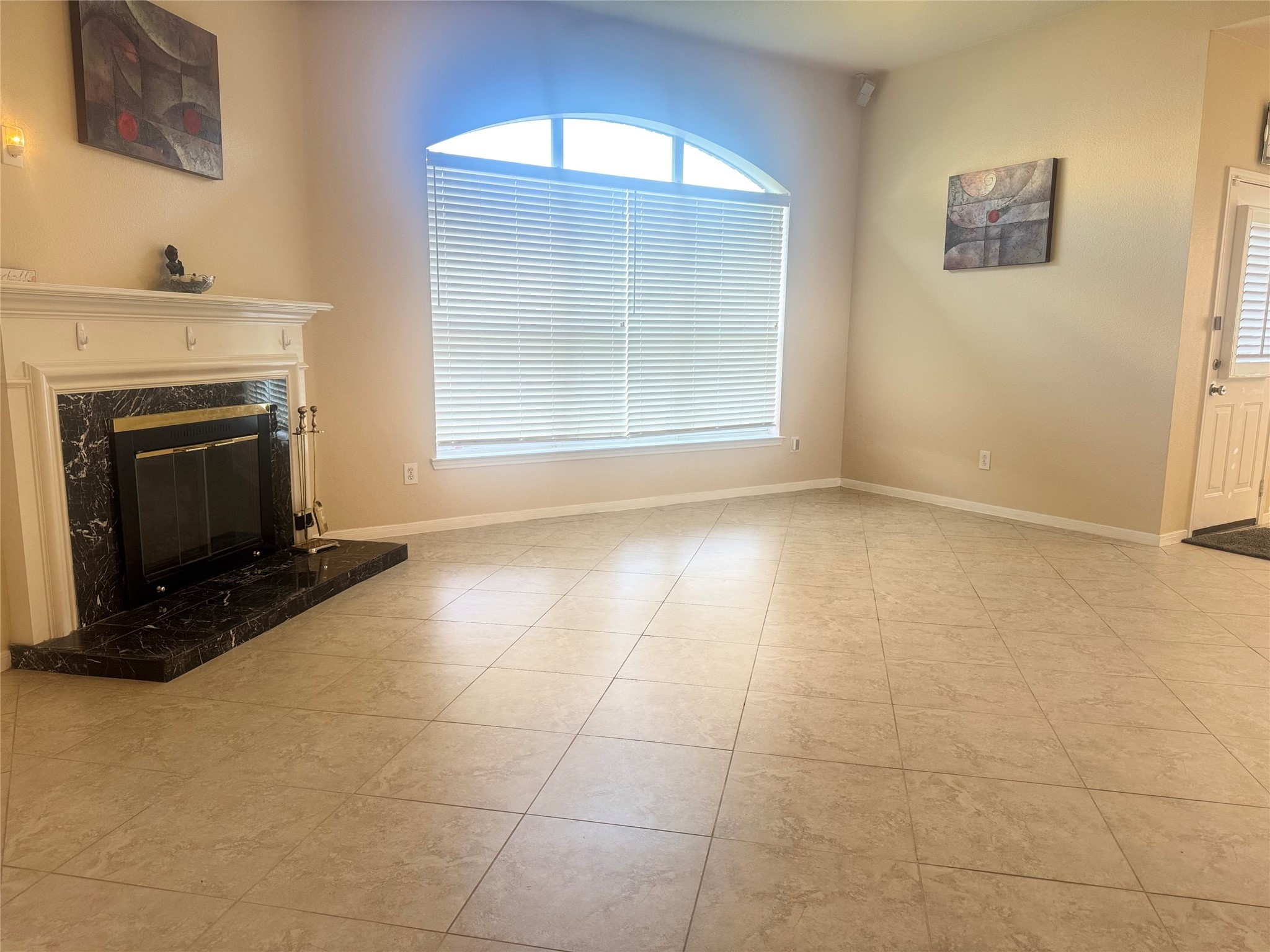 9810 Mossy Tree Lane Houston, TX 77064 - Photo 22 of 24 a view of an empty room with a fireplace and a window