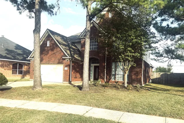 a view of a house with snow on the tree