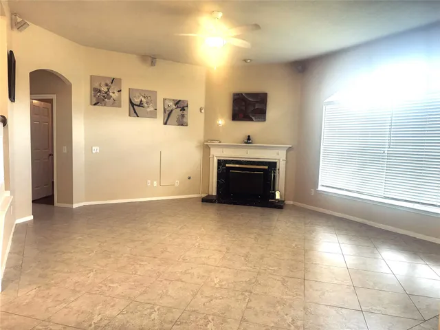 a view of empty room with a fireplace