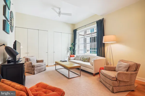 a living room with furniture a lamp and a window