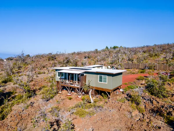 a view of a house with a yard and sitting area