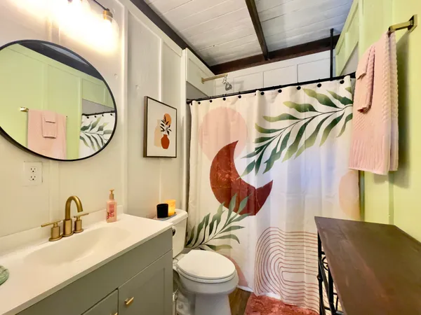 a bathroom with a sink a toilet and a mirror