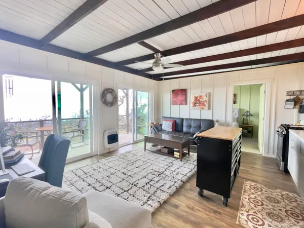 a living room with furniture a large window