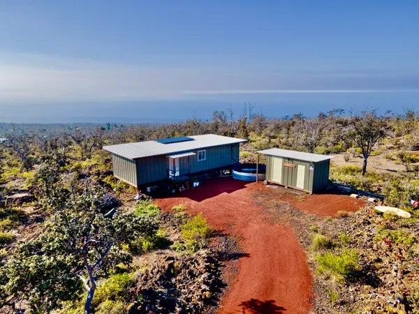 an aerial view of a house with a yard