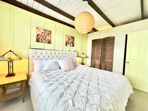 a bedroom with a bed and a chandelier