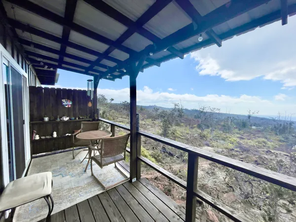 a view of a porch with furniture and wooden floor
