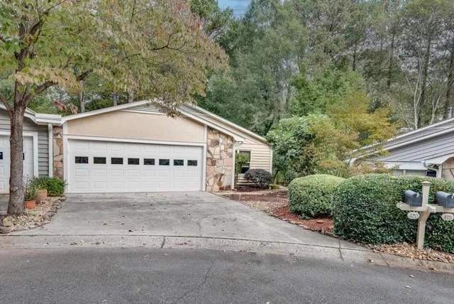 a view of a house with a garage and a car parked