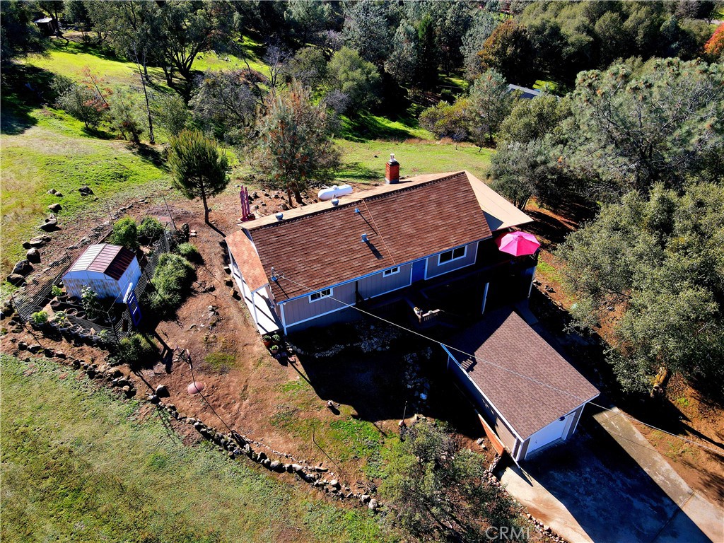 an aerial view of a house with yard swimming pool and green space