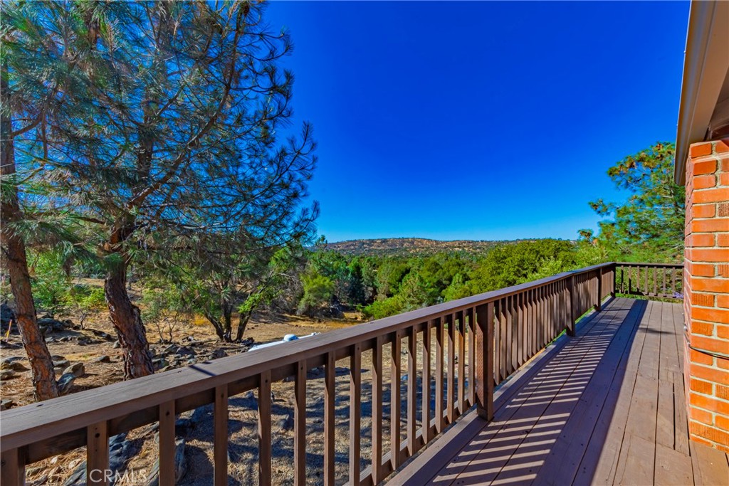43629 Ranger Cir Drive Coarsegold, CA 93614 - Photo 28 of 54 a balcony with wooden floor and trees in the back