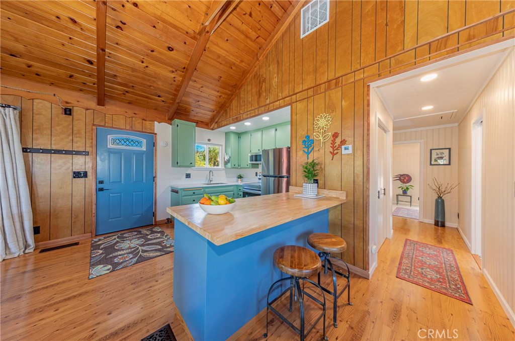 43629 Ranger Cir Drive Coarsegold, CA 93614 - Photo 7 of 54 a view of a kitchen with kitchen island dining table and wooden floor