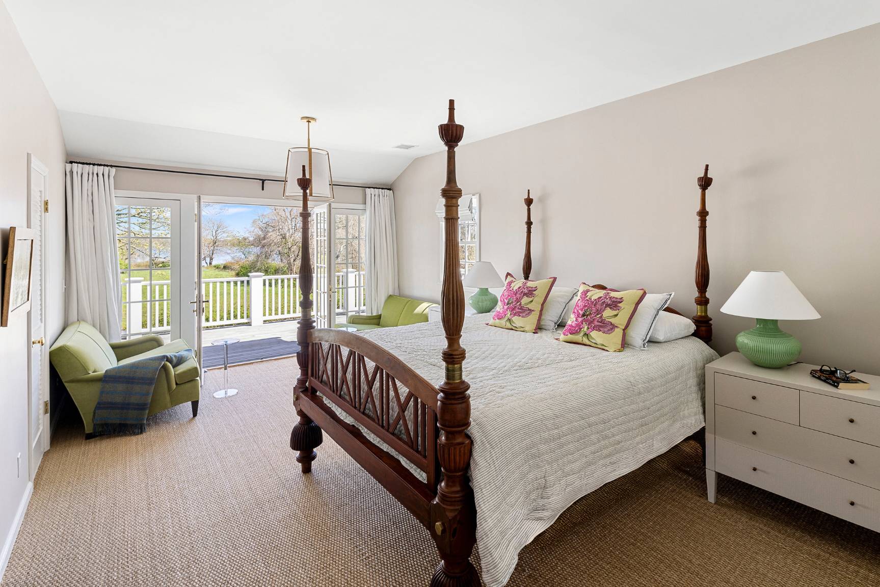 429 Head Of Pond Road Water Mill, NY 11976 - Photo 11 of 22 a bedroom with a bed and a chandelier