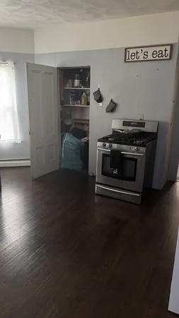 a kitchen with granite countertop a stove and a refrigerator