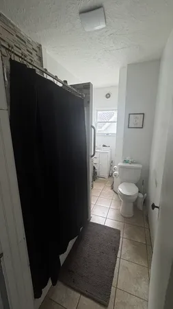 a bathroom with a toilet and a shower
