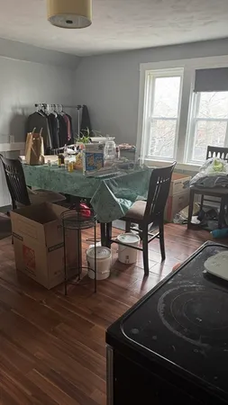 a dining room with furniture and wooden floor