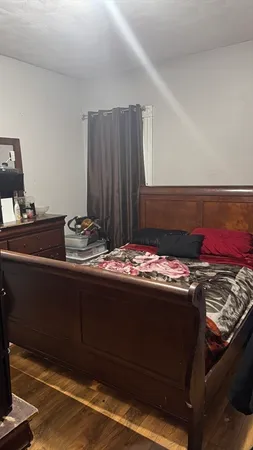 a room with a bed and a dresser