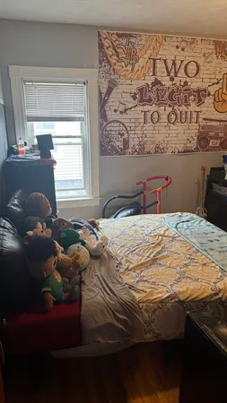 a bedroom with a bed and a window