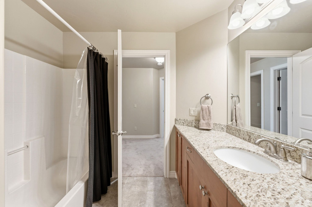 7235 Viansa Court Midvale, UT 84047 - Photo 25 of 43 Bathroom featuring vanity, shower / bath combination with curtain, and light tile patterned floors