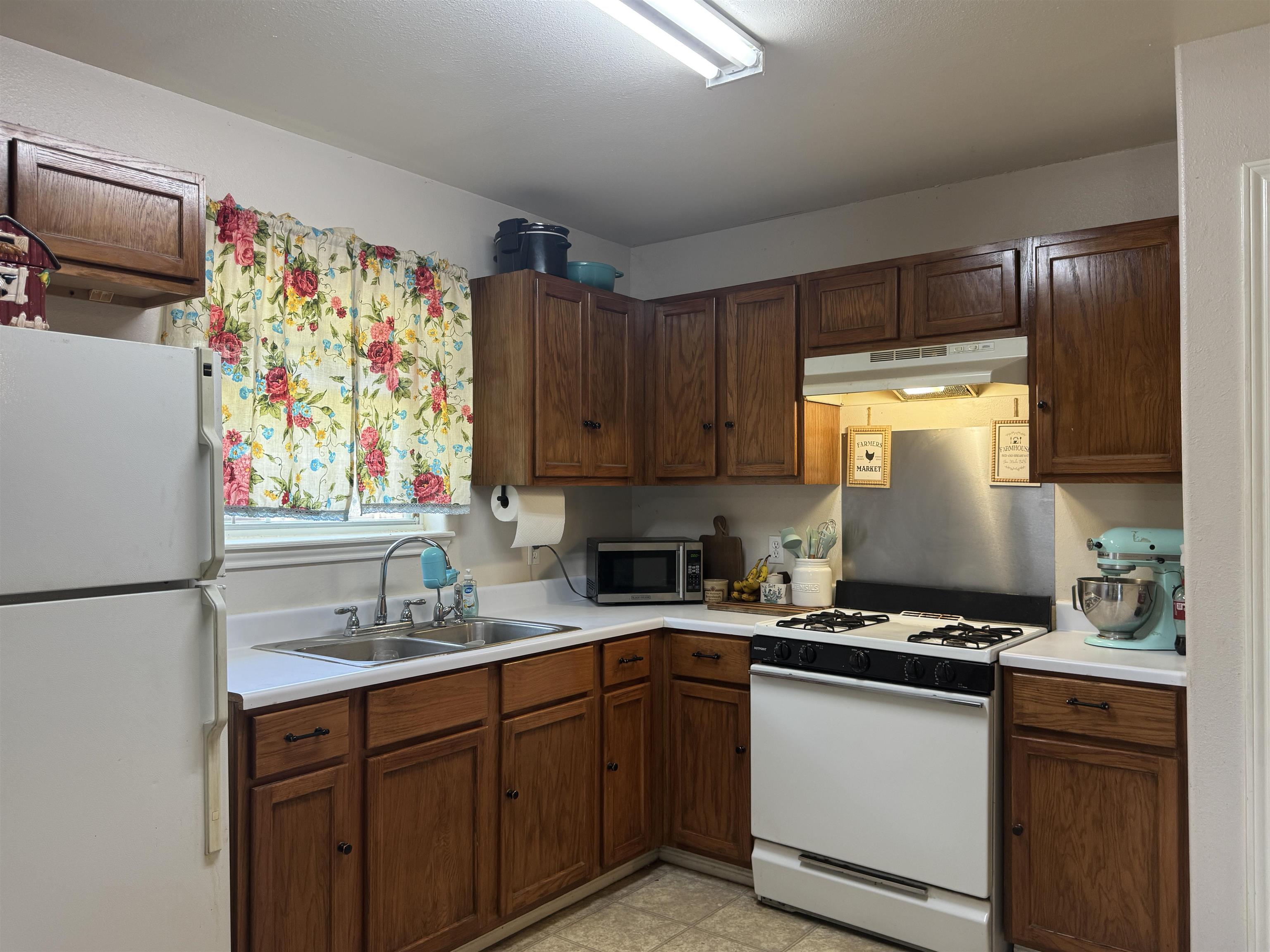 200 North 7th Street Lometa, TX 76853 - Photo 2 of 16 a kitchen with stainless steel appliances a sink stove and refrigerator