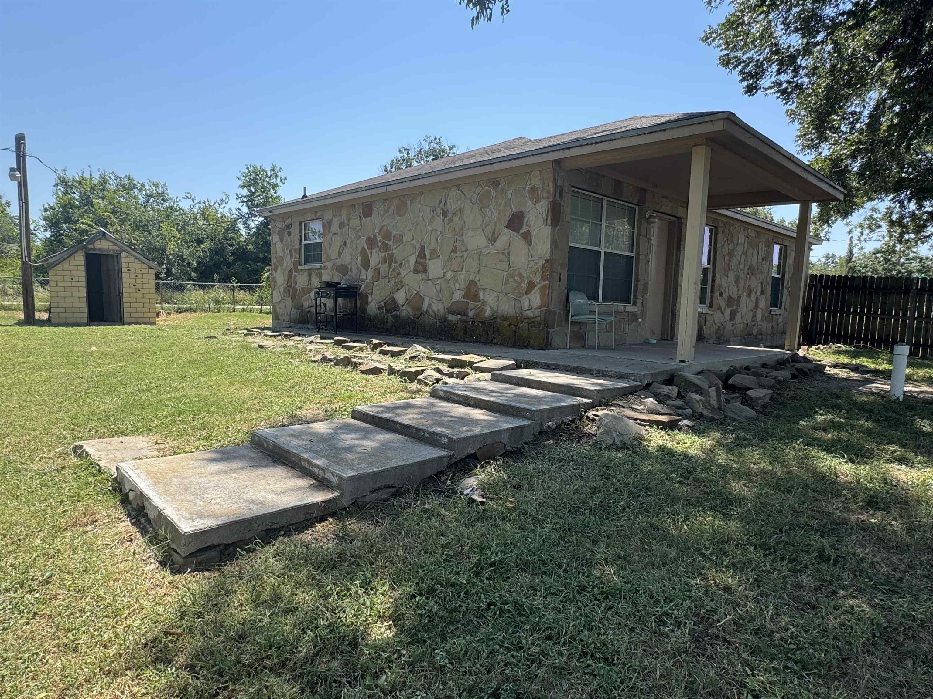 200 North 7th Street Lometa, TX 76853 - Photo 3 of 16 a view of a barn in the middle of a yard