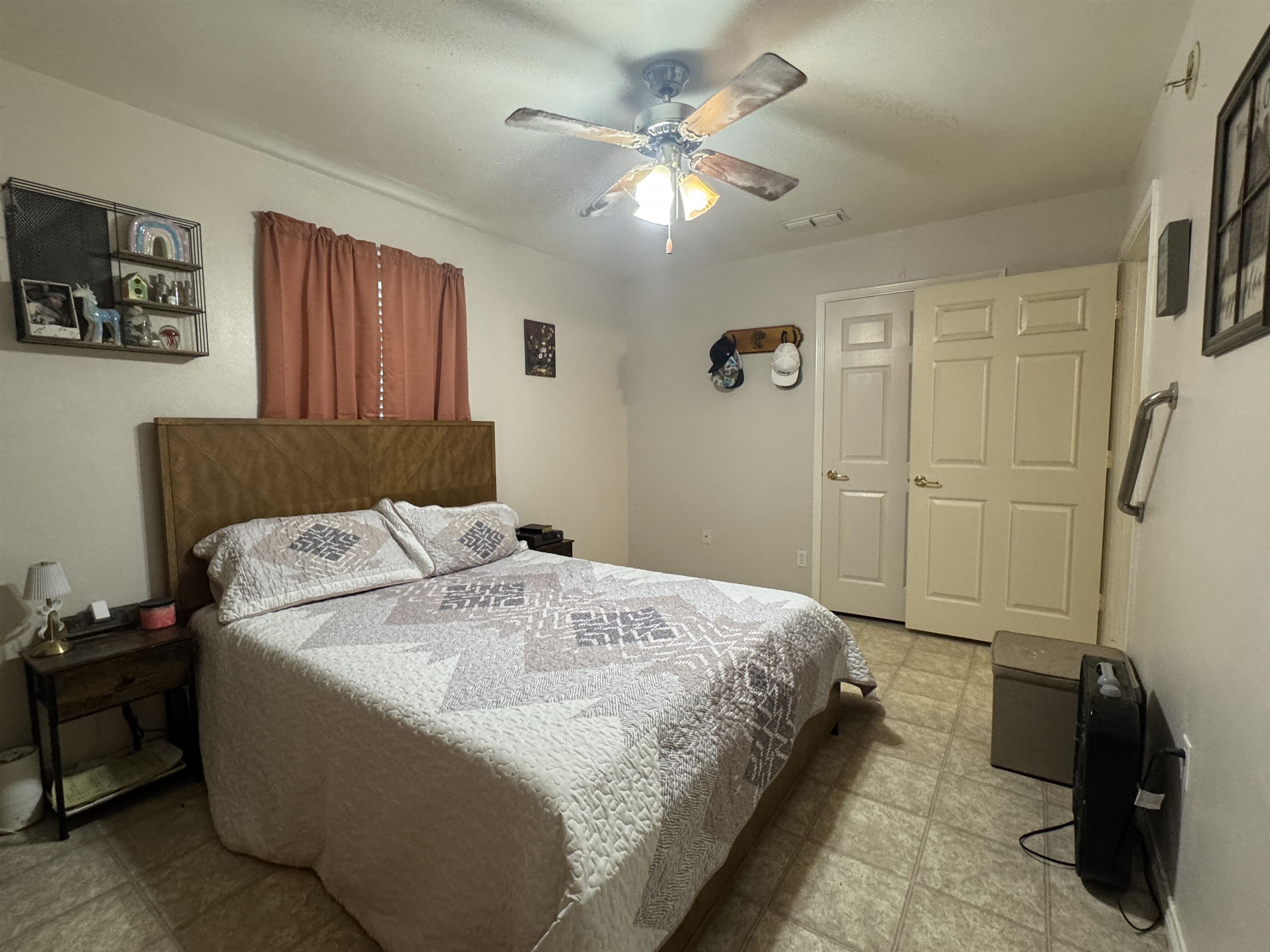 200 North 7th Street Lometa, TX 76853 - Photo 8 of 16 a spacious bedroom with a bed and a chandelier